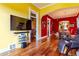 Hardwood floors accent the living space with a modern television and seamless flow to the dining area at 233 W 3Rd Ave, Denver, CO 80223