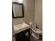 A sleek bathroom with a modern sink, elegant fixtures, and a neatly arranged toilet at 2238 S Nile Ct, Aurora, CO 80014