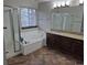 This bathroom features a shower, soaking tub, and vanity at 2238 S Nile Ct, Aurora, CO 80014