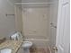 Bathroom featuring a single vanity and tub shower, complemented by neutral-toned wall and floor tiles at 2238 S Nile Ct, Aurora, CO 80014