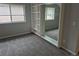 Bedroom featuring a built-in shelving unit and a mirrored closet, enhancing space and storage while complementing the gray carpet at 2238 S Nile Ct, Aurora, CO 80014