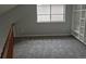 Bedroom with gray carpet, complemented by natural light and a built-in shelving unit, offering ample storage and style at 2238 S Nile Ct, Aurora, CO 80014