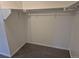 This empty walk-in closet features a rod and a shelf at 2238 S Nile Ct, Aurora, CO 80014