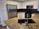 Modern kitchen featuring stainless steel appliances, granite countertops, and ample cabinet space at 2238 S Nile Ct, Aurora, CO 80014