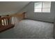 Loft featuring gray carpet and natural light from the window, creating a calming space for relaxation and productivity at 2238 S Nile Ct, Aurora, CO 80014