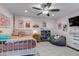 Cozy bedroom with a full bed, colorful artwork, bean bag, and ample space at 4840 Point Mesa St, Castle Rock, CO 80108