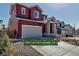 Charming two-story home featuring a two-car garage, stone pillar entry, and landscaped front yard at 4840 Point Mesa St, Castle Rock, CO 80108