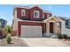 Charming two-story home with a two-car garage and stone-accented entryway in a residential neighborhood at 4840 Point Mesa St, Castle Rock, CO 80108