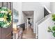 Welcoming foyer with neutral walls, wood floors, and a view into the dining area at 4840 Point Mesa St, Castle Rock, CO 80108