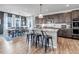 Open-concept kitchen featuring a large island, stainless steel appliances, and adjacent dining area at 4840 Point Mesa St, Castle Rock, CO 80108