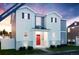Two-story home with red door, white and gray siding, and landscaping at 22311 E 38Th Pl, Aurora, CO 80019
