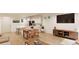 Modern kitchen with island, white cabinets, and hardwood floors at 22311 E 38Th Pl, Aurora, CO 80019