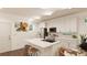 Modern kitchen with island, white cabinets, and hardwood floors at 22311 E 38Th Pl, Aurora, CO 80019