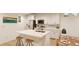 Modern kitchen features white cabinets, island, and stainless steel appliances at 22311 E 38Th Pl, Aurora, CO 80019