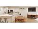 Modern kitchen with island, stainless steel appliances, and adjacent dining area at 22311 E 38Th Pl, Aurora, CO 80019