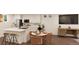 Modern kitchen with island and adjacent dining area with seating for four at 22311 E 38Th Pl, Aurora, CO 80019