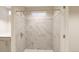 Modern shower with marble-look tile at 22311 E 38Th Pl, Aurora, CO 80019