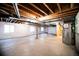 Spacious unfinished basement with open ceiling and concrete floor at 8387 Fig St, Arvada, CO 80005