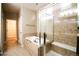 Bright bathroom features large soaking tub with shower and tiled surround at 8387 Fig St, Arvada, CO 80005