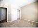 Cozy bedroom with neutral carpet and access to closet and hallway at 8387 Fig St, Arvada, CO 80005