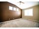 Spacious bedroom features large windows, neutral carpet, vaulted ceilings, and a ceiling fan at 8387 Fig St, Arvada, CO 80005