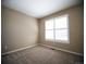Bright bedroom features a large sunny window and neutral carpet at 8387 Fig St, Arvada, CO 80005