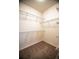 Walk-in closet with shelving and neutral carpet at 8387 Fig St, Arvada, CO 80005