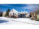 Charming two-story home with manicured landscaping, brick accents, gray siding, and a two-car garage at 8387 Fig St, Arvada, CO 80005