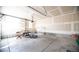 Large garage with high ceilings and natural light from the window at 8387 Fig St, Arvada, CO 80005