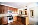 Updated kitchen featuring stainless steel appliances, granite countertops, and wood cabinets at 8387 Fig St, Arvada, CO 80005