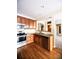 Updated kitchen featuring stainless steel appliances, granite countertops, and ample wood cabinets at 8387 Fig St, Arvada, CO 80005