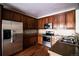 Well-appointed kitchen with stainless steel appliances, granite countertops, and ample wood cabinets at 8387 Fig St, Arvada, CO 80005