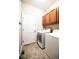 Convenient laundry room features washer, dryer, and storage cabinets at 8387 Fig St, Arvada, CO 80005