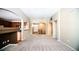 Spacious living room with a fireplace, large window, and seamless flow into the kitchen at 8387 Fig St, Arvada, CO 80005