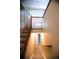 View of carpeted staircase with wood banister leading to lower level at 8387 Fig St, Arvada, CO 80005