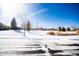 Winter street view featuring snow-covered lawns and houses at 8387 Fig St, Arvada, CO 80005