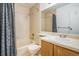 Standard bathroom features a tub with a shower, framed mirror and a single sink vanity at 904 S Walden Way # 203, Aurora, CO 80017