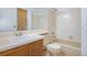 Standard bathroom features a tub with a shower, framed mirror and a single sink vanity at 904 S Walden Way # 203, Aurora, CO 80017