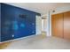Bedroom featuring carpet flooring, closet and blue accent wall at 904 S Walden Way # 203, Aurora, CO 80017