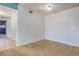 An empty bedroom with neutral carpet, off-white paint, and views to an adjacent room at 904 S Walden Way # 203, Aurora, CO 80017