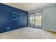 Spacious bedroom with large sliding glass doors to balcony, allowing natural light and outdoor access at 904 S Walden Way # 203, Aurora, CO 80017