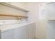 Bright laundry room area with storage shelves and white washer and dryer at 904 S Walden Way # 203, Aurora, CO 80017