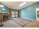 Spacious living room with a fireplace, skylight, and balcony access, creating a bright and inviting atmosphere at 904 S Walden Way # 203, Aurora, CO 80017