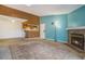 Open-concept living room featuring a stone fireplace, a skylight, and an adjacent kitchen area at 904 S Walden Way # 203, Aurora, CO 80017