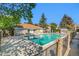 Community pool surrounded by lush landscaping and fencing at 904 S Walden Way # 203, Aurora, CO 80017