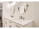Bright bathroom with dual sinks, marble countertops, white cabinets, and modern fixtures, creating a clean and stylish space at 6187 Wescroft Ave, Castle Rock, CO 80104