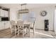 Bright dining area featuring a modern chandelier, large windows, and a stylish dining table at 6187 Wescroft Ave, Castle Rock, CO 80104