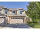 Charming two-story home featuring a two-car garage, stone accents, and manicured landscaping at 6187 Wescroft Ave, Castle Rock, CO 80104