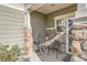 Cozy covered front porch with stone pillars, seating, and a welcoming atmosphere at 6187 Wescroft Ave, Castle Rock, CO 80104
