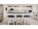 Charming kitchen with white cabinets, a large island with seating, and modern stainless steel appliances, creating a functional space at 6187 Wescroft Ave, Castle Rock, CO 80104